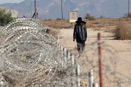 Police officers in Cyprus guard the Egoza razor wire