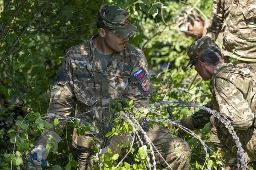Dismantling concertina wire in Slovenia